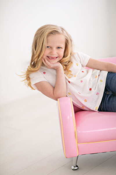 Little girl missing her top two front teeth during photos with Boise Photographer Tiffany Hix in her Boise portrait studio