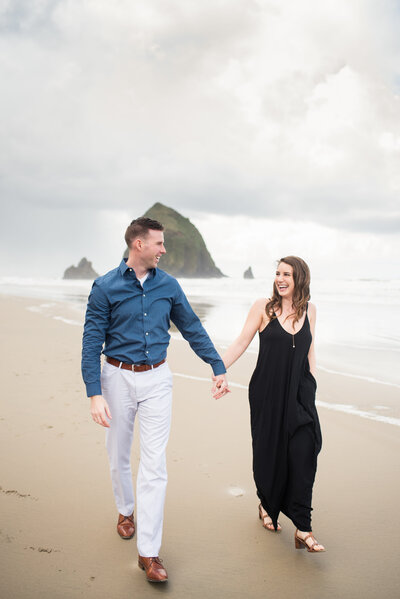Couple strolling on Cannon Beach in Oregon