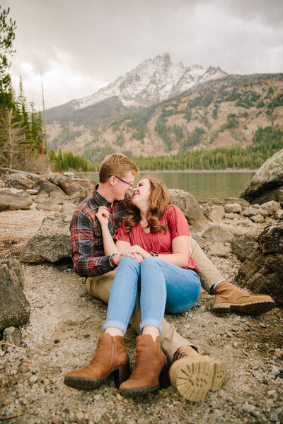 Jackson Hole wedding photographer captures couple sitting together during engagement photos