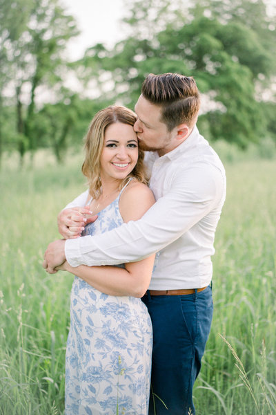 man kissing a woman on the head