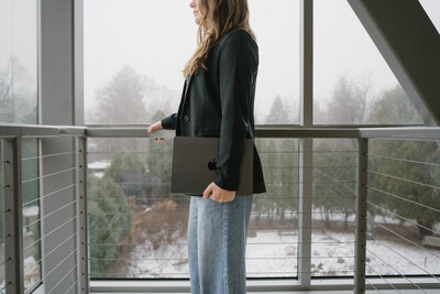 Social media manager holding Apple laptop