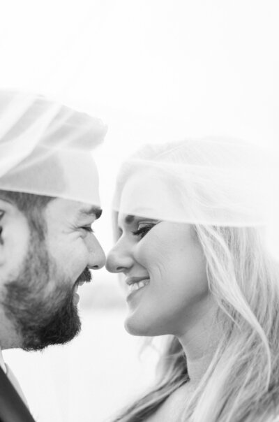 bride and groom under veil at fountain of youth wedding