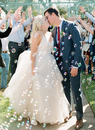 Bubble exit with bride and groom kissing at Austin wedding