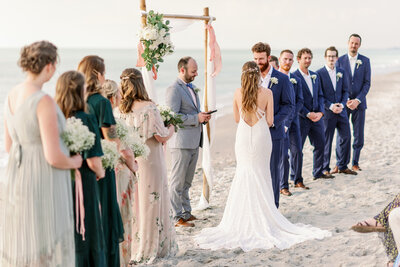 View of bridal party and bride and groom standing at the altar on Captiva  Island, FL