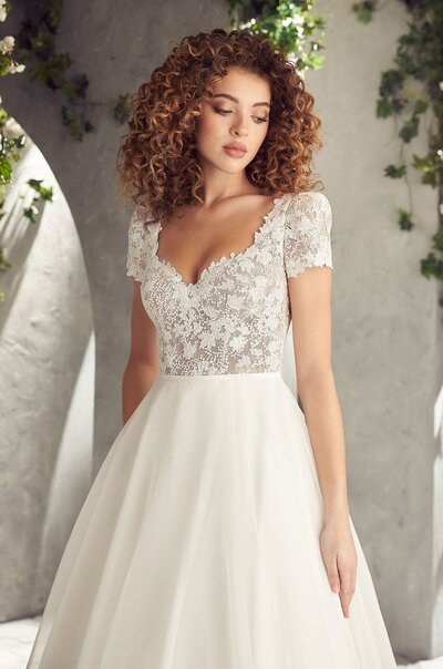 Mikaella Lace Wedding Dress. Mikaella Lace gown with sleeveless bodice and plunging neckline. Removable Mokuba Ribbon with beading at waist. Full circle skirt with pockets and scallop at hem.