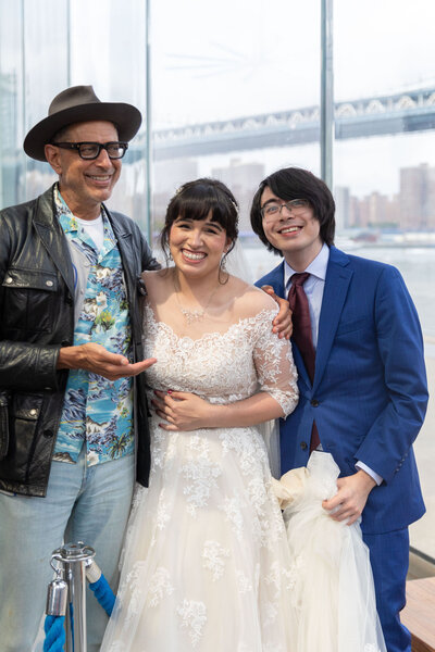 Jeff Goldblum posing with a wedding couple.