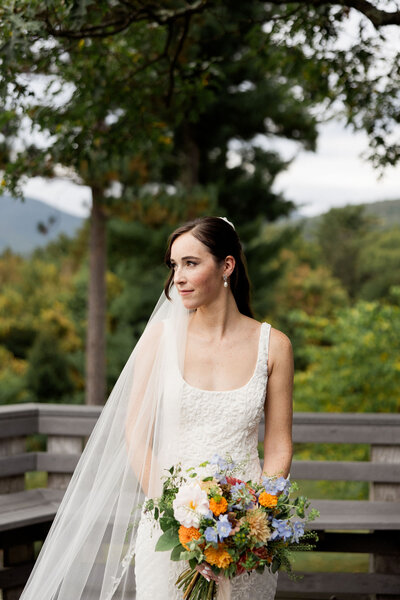 Bridge looks off at the Catskill Mountain Range during her Wedding at Onteora Mountain House
