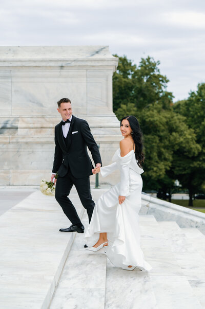 Newport RI Wedding Photographer | Rhode Island Caprio Captured Photography | Bride And Groom Holding Hands While Walking Up The Stairs