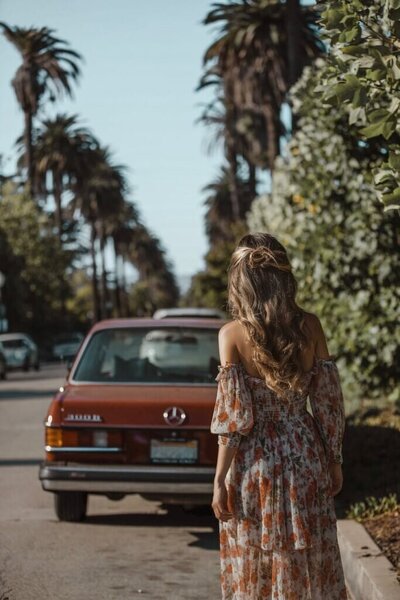 Woman in floral dress walking down a street in Beverly Hills California