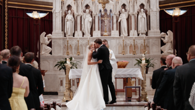 bride and groom standing together in a Catholic church
