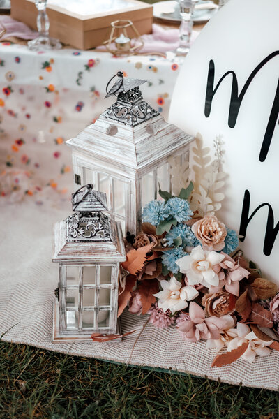 Styled picnic proposal setup with florals and champagne for Krizzia and Mary in Auckland, photographed by Zanthe Vorsatz.