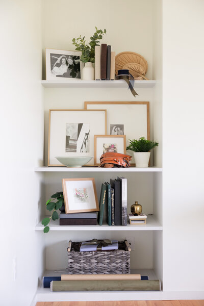 built in shelf with photos and albums displayed