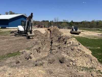 Skid steer next to dirt for septic install
