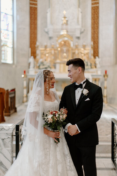 Bride and groom smiling at each other