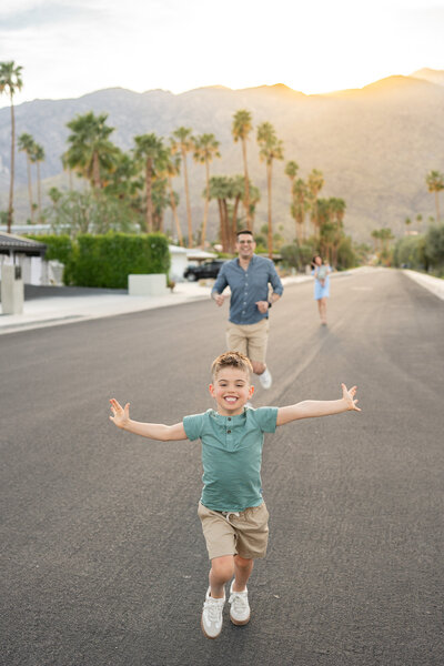 A little boy is running and playing with his dad in a Palm Springs neighborhood. 