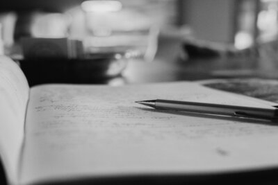 filled in notebook with clicker pencil laying on top of a desk