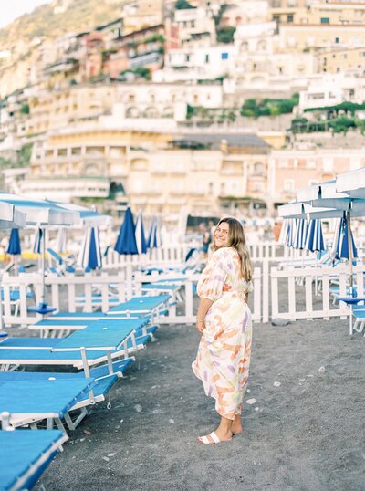 Carissa in flowy dress in front of Italian backdrop