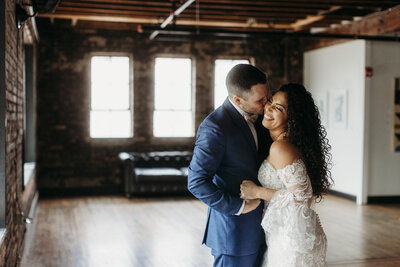 Bride and groom hold hands for a first touch under Spanish moss at Plantation Oaks outdoor ceremony space in Callahan FL.