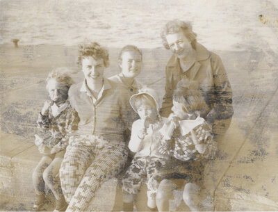 two women with four children. Three of the children are eating ice cream. 