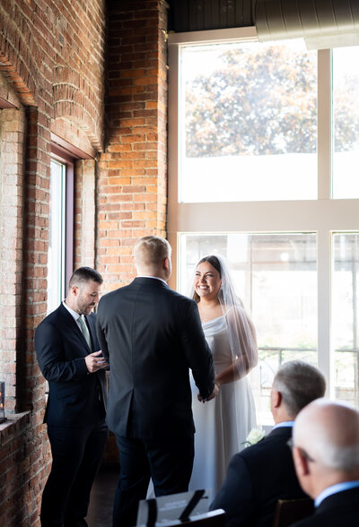 bride and groom exchanging vows during intimate wedding in the Flats Cleveland, Ohio