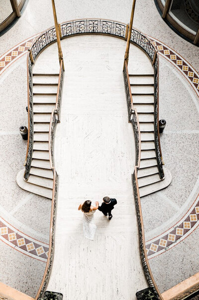 overhead picture of bride and groom on the stairs at the cleveland hyatt at the arcade