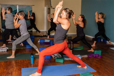 Staff photo Yoga instructor leading students through pose Zen Wellness