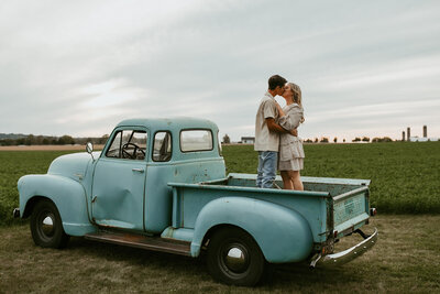 Couples hugging during their session in the back of a truck in Waterloo, Ontario.