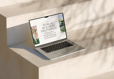 A laptop setting on stone stairs.