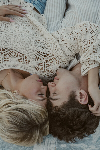 Big Sur Elopement Photographer- couple enjoying some time together laying down on a picnic blanket