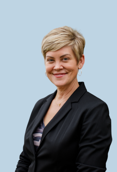 smiling woman with short blonde hair wearing a black blazer