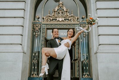 elopement couple cheers leaving san francisco city hall