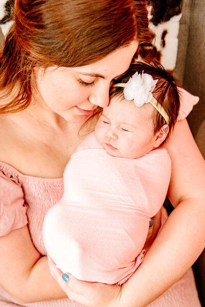 mom in Arizona holding her stomach for maternity session with photographer of Cactus & Pine Photography LLC