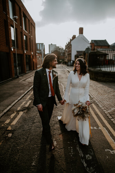 A stylish wedding couple walk the streets of London on their wedding day. 