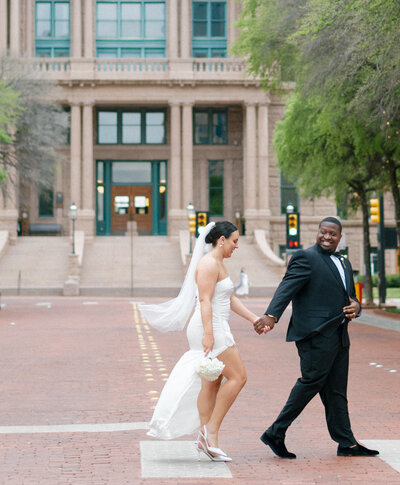 Couple walking in front of fort worth courthouse in tarrant county tx