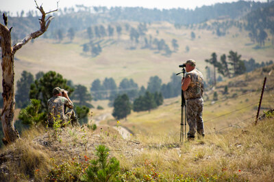 Two guys glassing from a ridge top in the west hills of Nebraska 