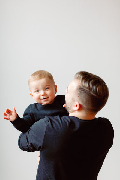 Toddler waving to camera during a family session in Rochester, NY.