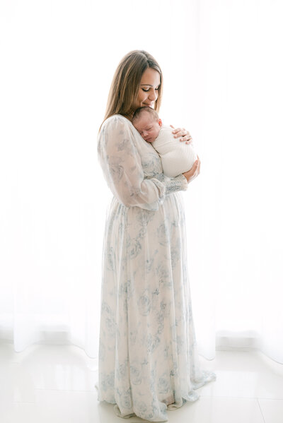 mom snuggling with her new baby Miami Newborn Photography