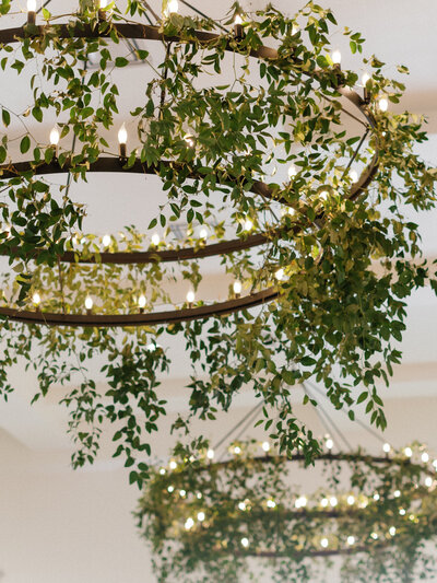 Hanging light fixtures decorated with greenery