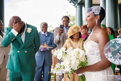 Newlyweds joyfully exiting their wedding ceremony, surrounded by loved ones in Raleigh, NC.