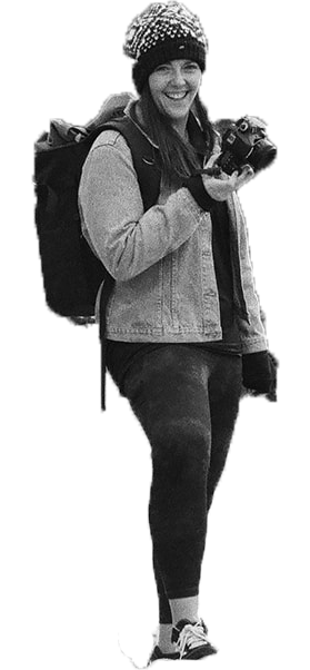 Black and white photo of hiker holding a camera