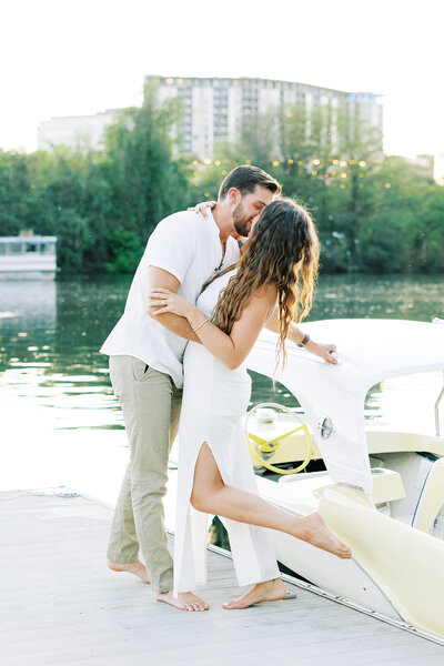 Couple kissing beside a boat on the water