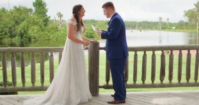 bride and groom reading letters to each other on porch