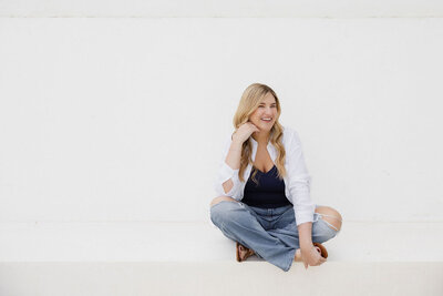 Brogan seated outside wearing casual attire