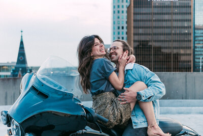 Rooftop casual engagement photos with a motorcycle.