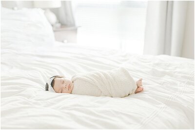 Newborn baby girl swaddled on the bed at a Maryland Newborn Session