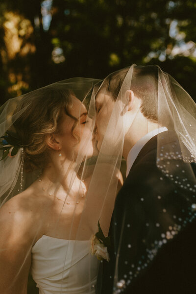 couple kissing intimately in a forest