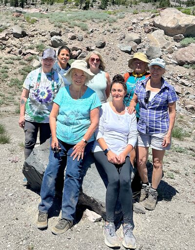 Samarah Grace and women sitting on a rock smiling reiki retreat