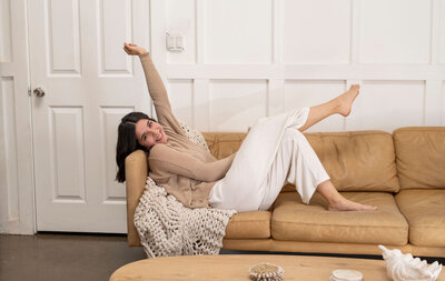 girl sitting on couch during photoshoot