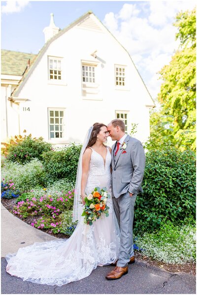 groom kissing bride on the forehead in an outdoor wedding with blush and white bouquet – Asheville NC Wedding Photographer | Tracy Waldrop