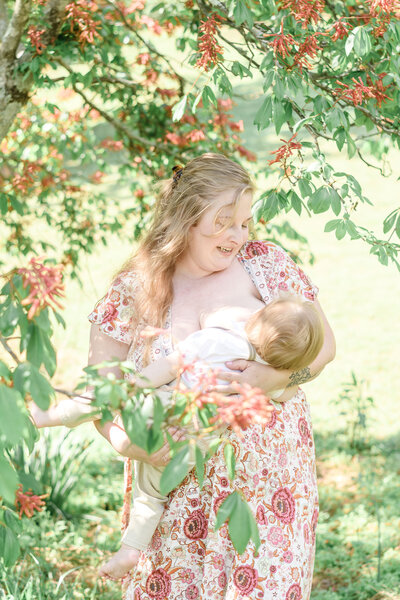 Mom breastfeeding her baby in nature